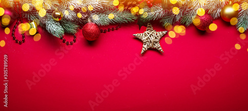 Fototapeta Naklejka Na Ścianę i Meble -  Red New Year or Christmas background with fir branch and Christmas decor.