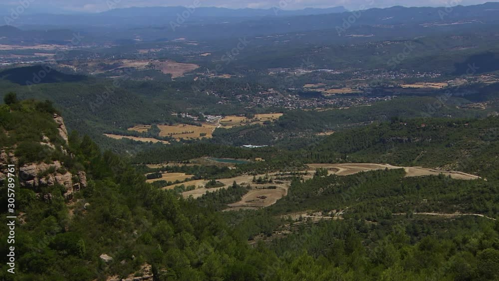 Wide high-angle aerial still shot of remote, rugged slopes and valleys from Montserrat highlands, Catalonia, Spain