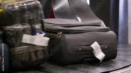 Baggage carousel. Bags, suitcases and other luggage moves on conveyor belt at the baggage reclaim area at an arrival airport.