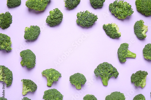 Fresh tasty broccoli on violet background, flat lay. Space for text