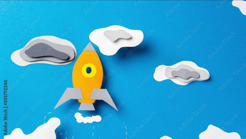 Rocket flies through the clouds, stop motion animation. Paper art. Business start up concept.