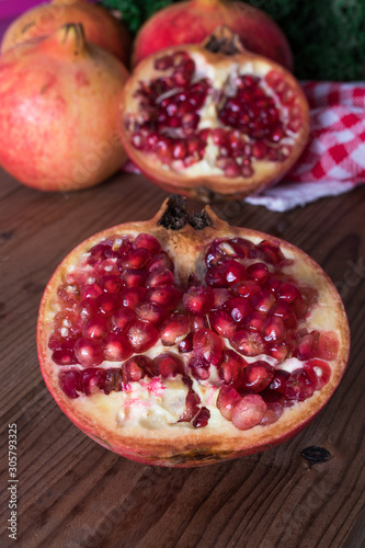 fresh ripe pomegranate open on wooden background, fruits