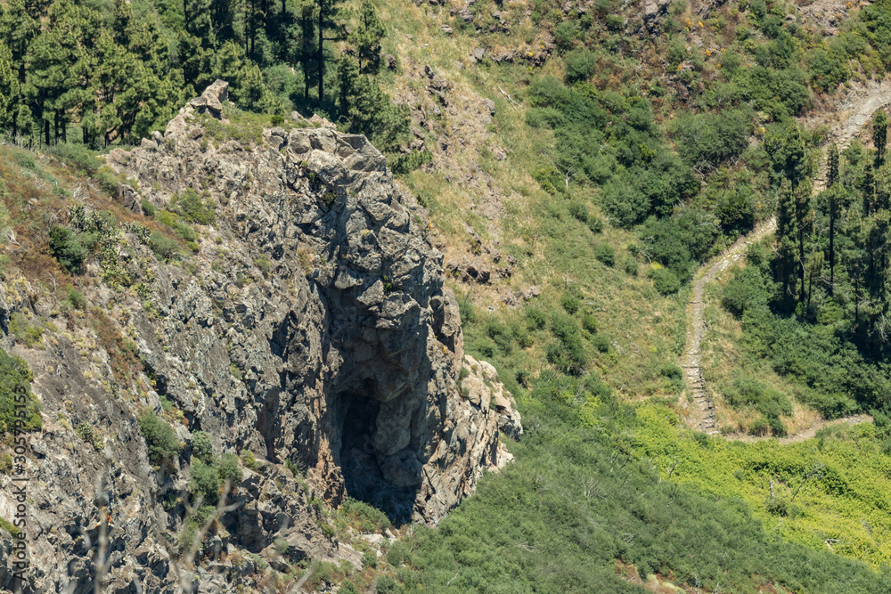 Los roques and famous Agando rock - cult place near Garajonay national park at La Gomera. Old volcanic mountain peaks. Thickets of relic laurels and heather on steep green slopes. Canary. Spain Los roques and famous Agando rock - cult place near Garajonay national park at La Gomera. Old volcanic mountain peaks. Thickets of relic laurels and heather on steep green slopes. Canary. Spain