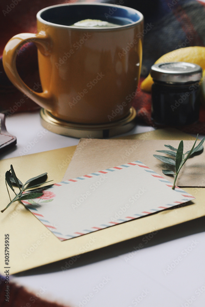 Cup of tea and leaves, postcard, winter home comfort