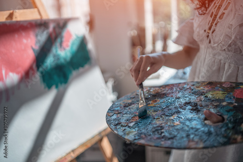 woman artist paint with brushes and oil dye