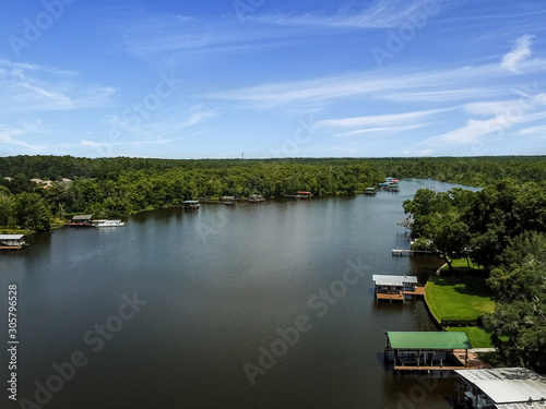 Aerial view of a long river with boat docks © Robert