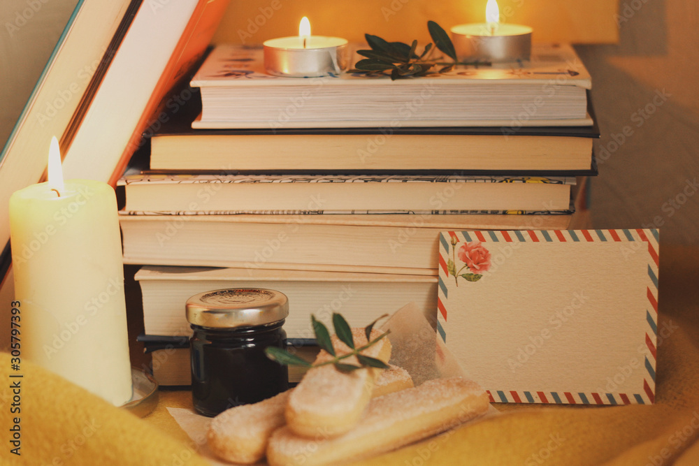 Books and candles, autumn home comfort and warm light