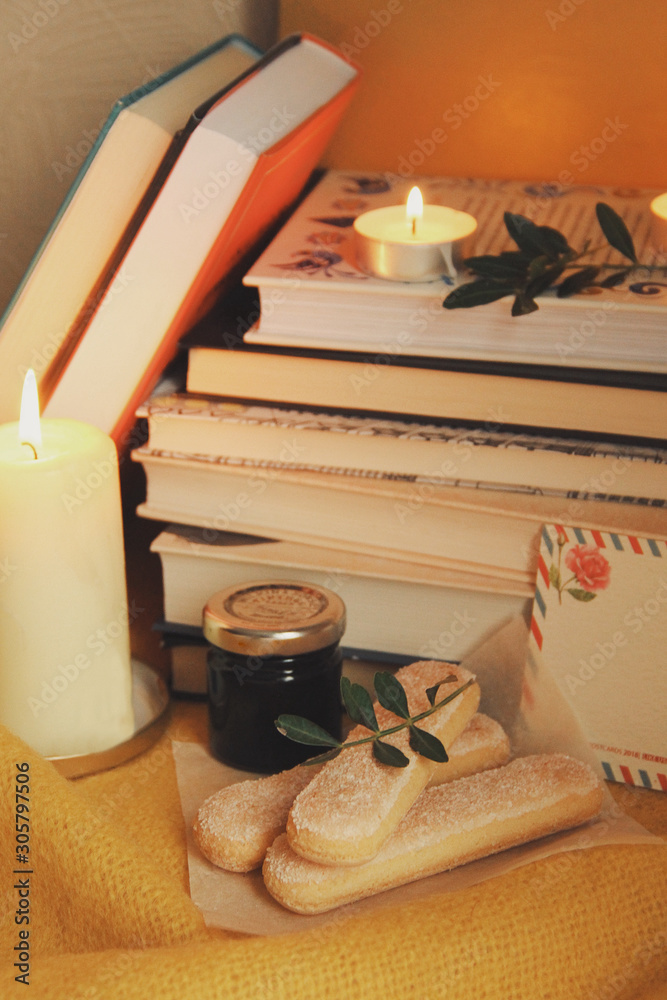 Books and candles, autumn home comfort and warm light