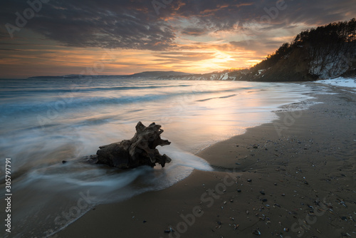 Dreamy seascape during sunset. Beautiful natural seascape. Sea sunset at a lake coast near Varna, Bulgaria. Magnificent sunset with clouds in the middle of spring The concept of leisure and freedom.