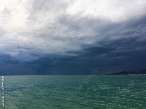 Turquoise sea on the background of thunderstorms