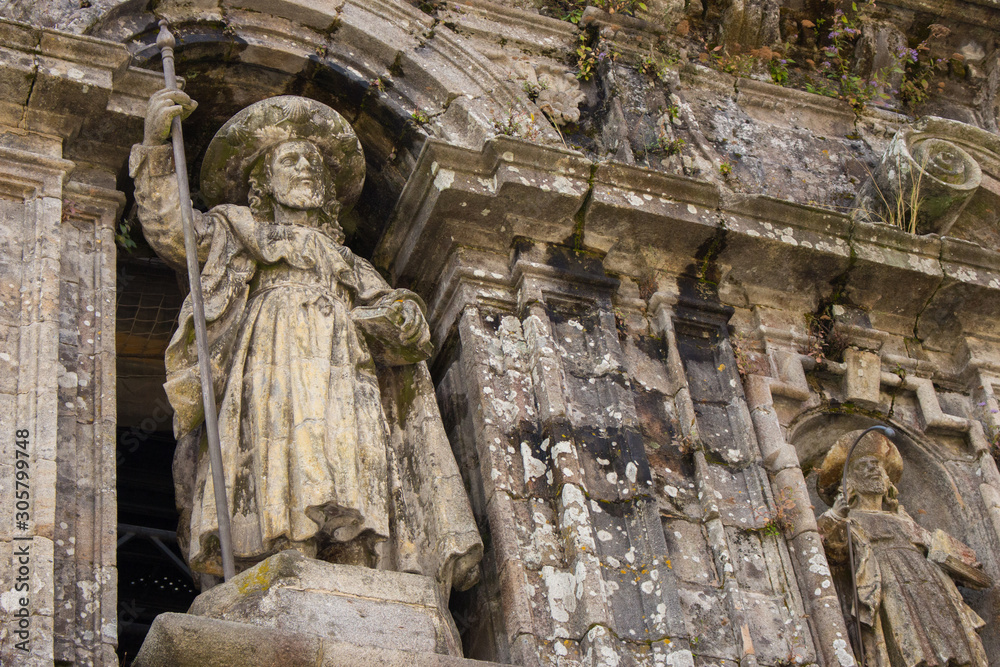 Santiago de Compostela, Spain - 10\13\2018: medieval statue of Saint Jacob at the church facade. Symbol of pilgrimage and travel. Monument of catholic saint James in Santiago de Compostela. 