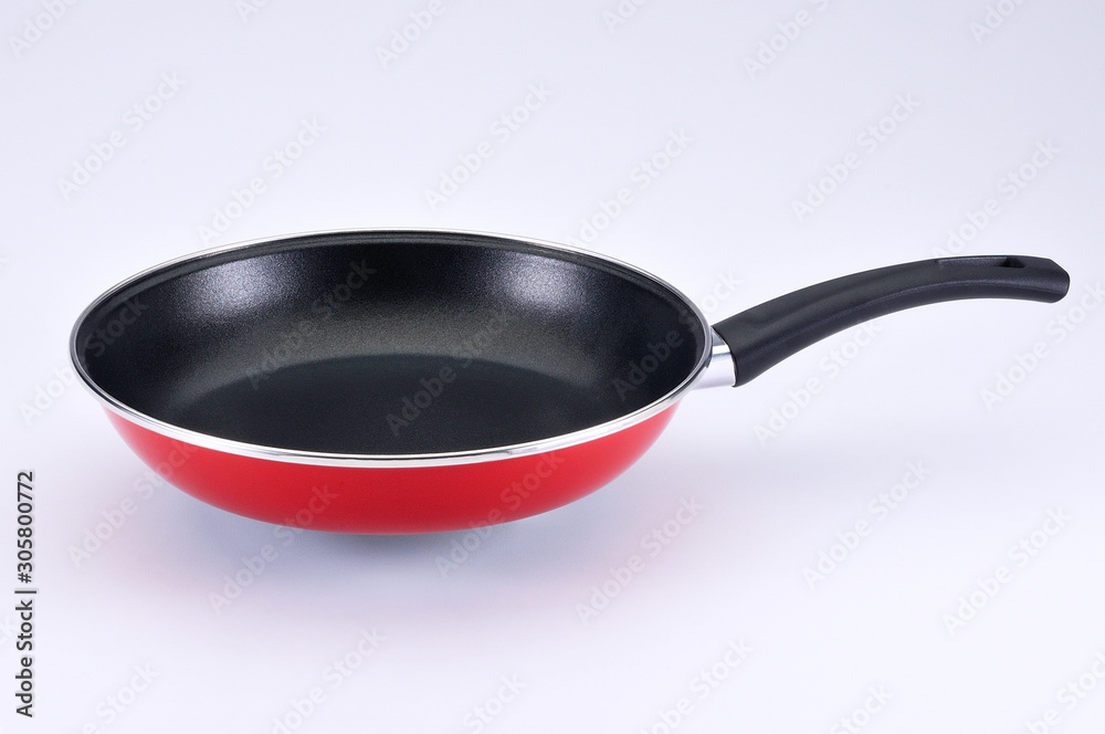 Red pan with black handle on white background Red pan with black handle on white background
