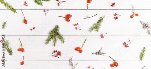 Christmas, New Year or Autumn background, flat lay composition of Christmas natural ornaments and fir branches, berries, rose hips and winter branches