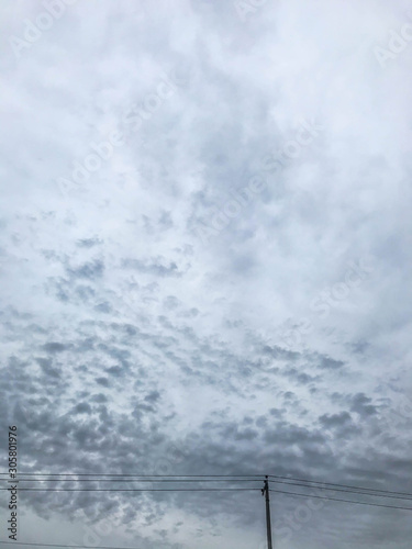 Cloudy sky behind of electric street lamp at rainy day