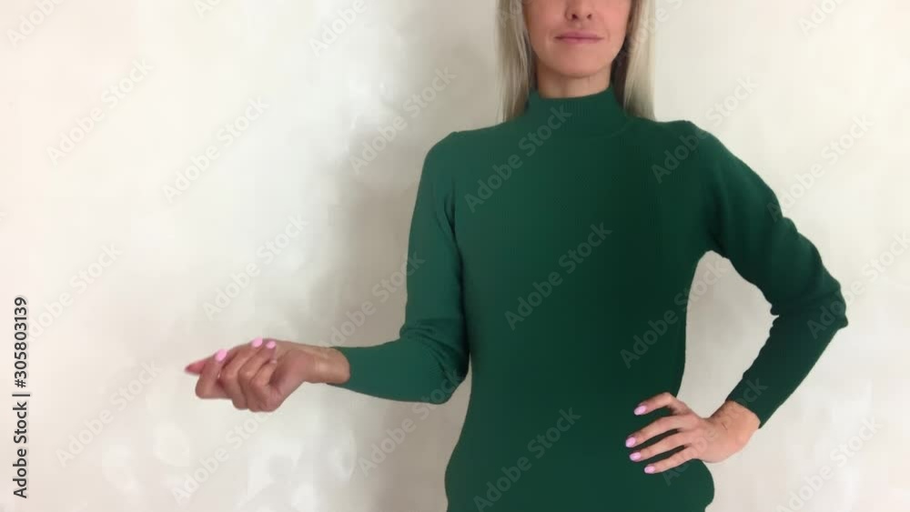 A woman changes clothes at the click of a finger. Sweaters, turtlenecks, pullovers of different colors. Variety of choices.