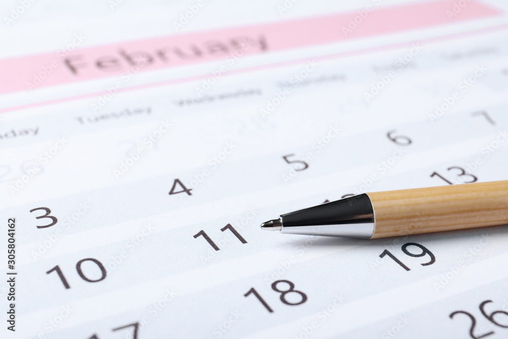 Pen on calendar page, closeup. Planning concept Pen on calendar page, closeup. Planning concept