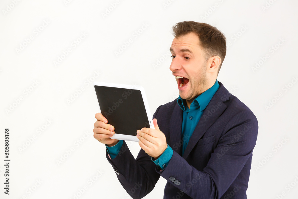 Smiling young man using tablet computer against a white background Smiling young man using tablet computer against a white background