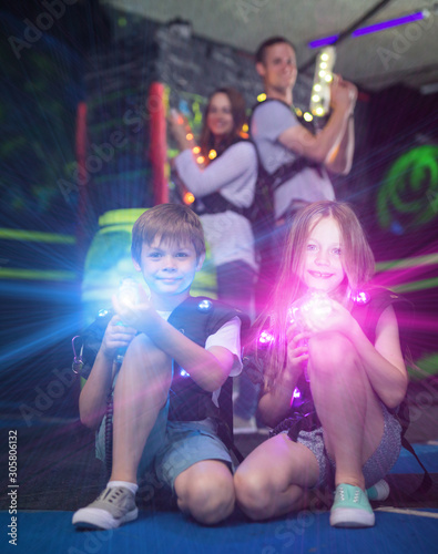 Kids sitting with laser guns in beams