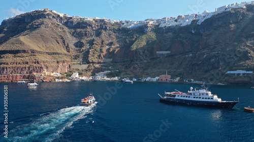 Aerial drone photo of iconic old port of Fira in volcanic island of Santorini, Cyclades, Greece photo