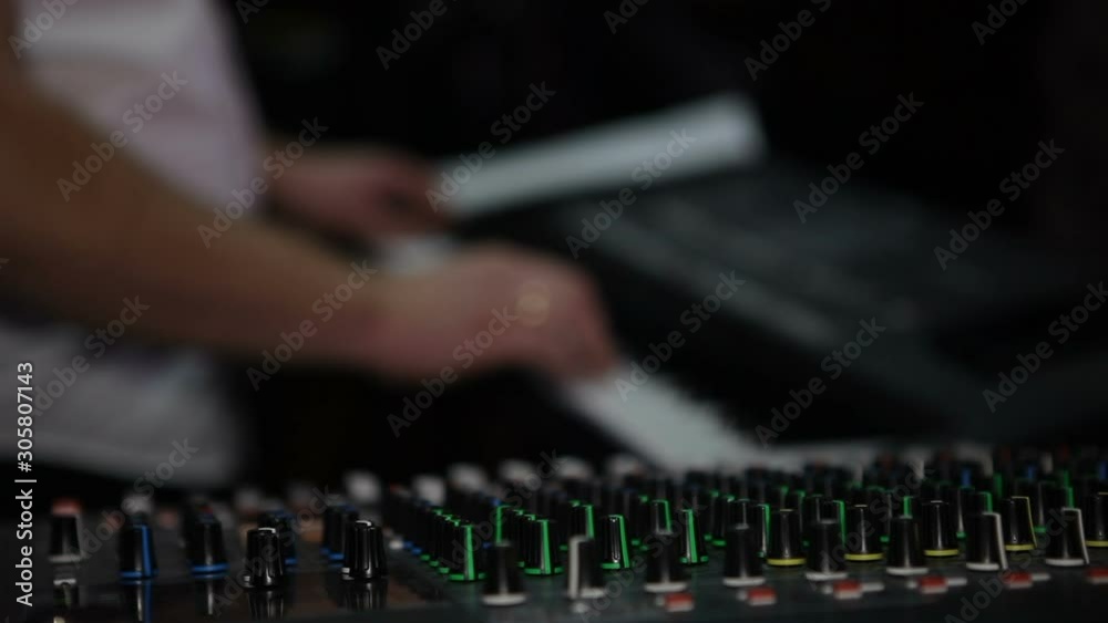 The musician plays the synthesizer in a nightclub. The musician plays the synthesizer in a nightclub.