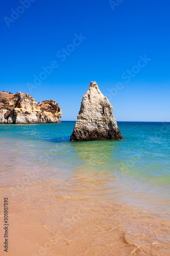 LANDSCAPE OF THE SEA WITH GREAT ROCK IN THE CENTER AND HORIZON OF BLUE SKY IN THE COAST OF PORTUGAL