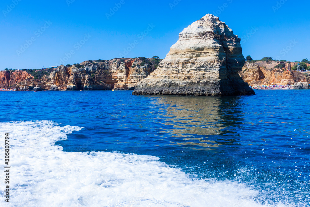 Fototapeta premium LANDSCAPE ON THE PORTUGAL COAST WITH ROCKS CLIFFS AND SEA FOAM IN FIRST PLANE