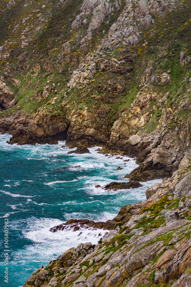 SEA LANDSCAPE WITH WAVES SUCKING AGAINST ROCKS CLIFFS ON THE PORTUGAL COAST