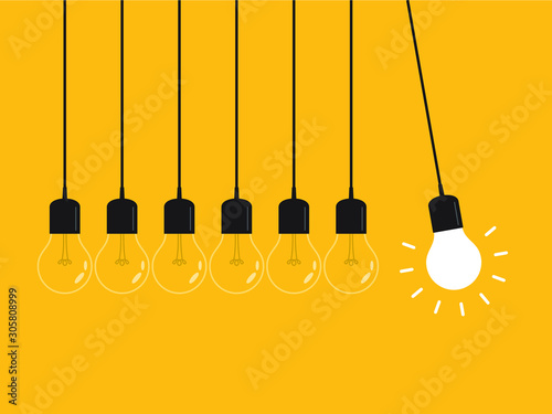 Newton's cradle with glowing light bulb. Pendulum. Leadership, power and uniqueness concept.