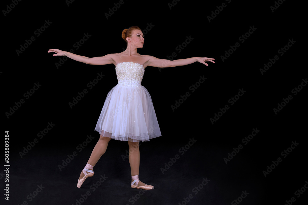 Naklejka premium the ballerina in pointes and a dress dances on a black background