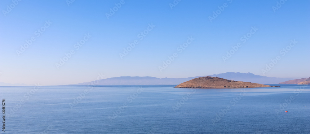 Aegean Sea with calm blue water and islands. Summer holiday concept and travel background