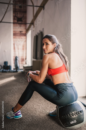 Tired girl resting on a medball between exercises - slim figure © andrey gonchar