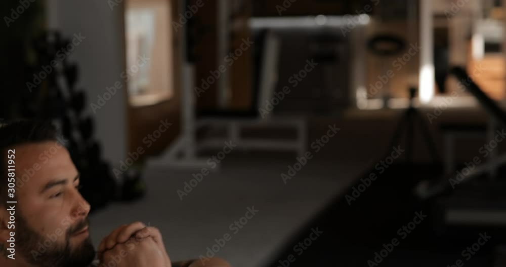 Man training in a gym making exercise for abs muscles on the angle bench Man training in a gym making exercise for abs muscles on the angle bench