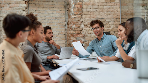 Together we can do so much. Group of young business people discussing something while working together in the creative office