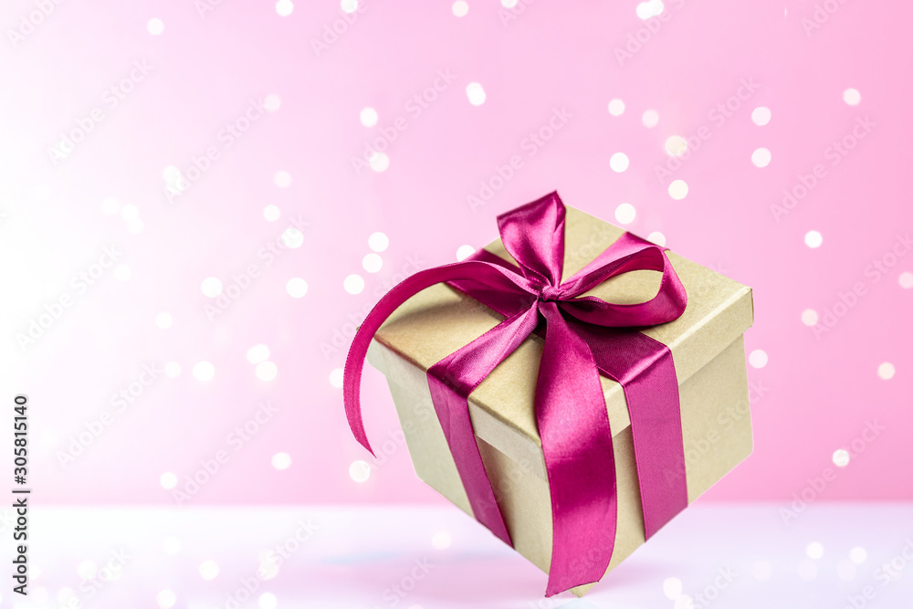 Gift box red ribbon isolated on pink background. Xmas present. Christmas surprise. Festive backdrop for holidays Birthday