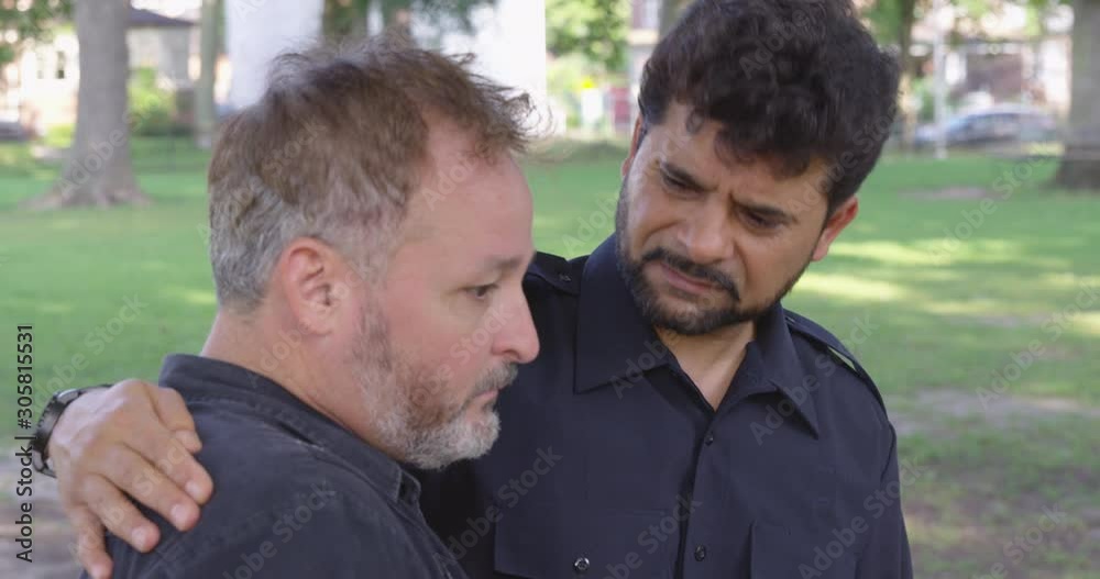 Medium Shot - A man comforts another man outside at a park - shot on RED Medium Shot - A man comforts another man outside at a park - shot on RED