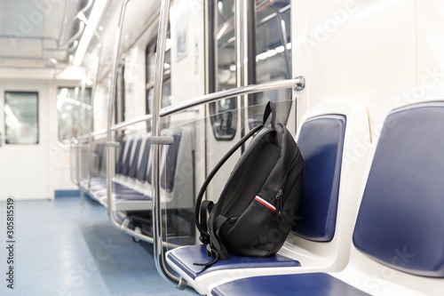 фотографія Forgotten leather black backpack/bag or bomb to commit a terrorist attack lies on a seat in subway train, public transport