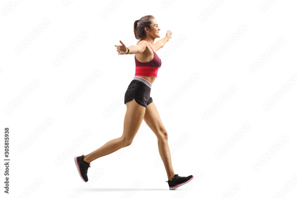 Happy young woman jogging and spreading arms