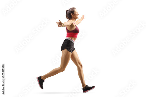 Fototapeta Naklejka Na Ścianę i Meble -  Happy young woman jogging and spreading arms
