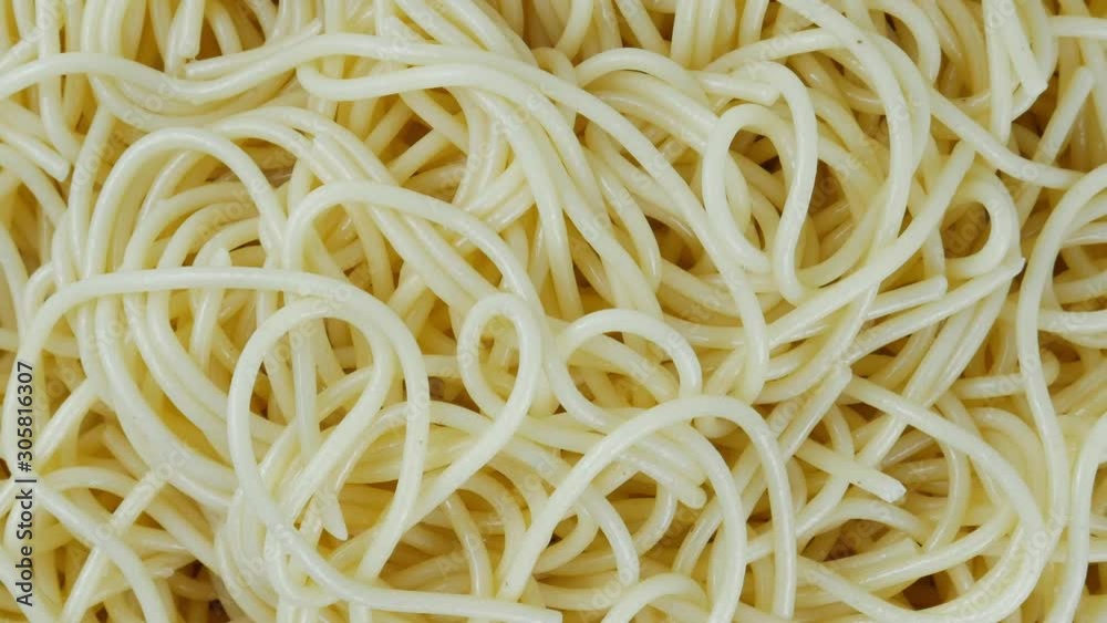 Close up Move the camera angle from left to right, Spaghetti yellow italian pasta line pattern food background concept, Top view, Blank for design. Close up Move the camera angle from left to right, Spaghetti yellow italian pasta line pattern food background concept, Top view, Blank for design.