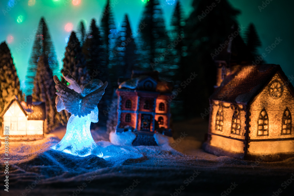 New Year miniature house in the snow at night with fir tree. New Year miniature house in the snow at night with fir tree.