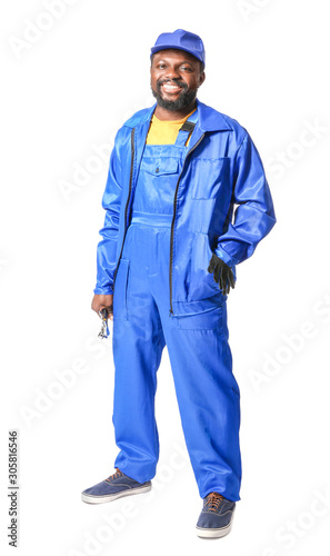 African-American car mechanic on white background