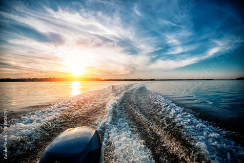 Deep river. Crossing from coast to coast. Very beautiful path on the water behind the stern of the boat from the engine