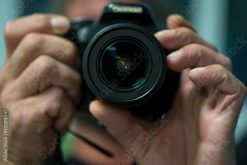 man using reflex photo camera photo