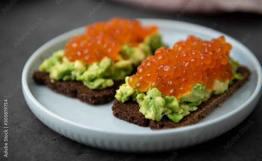 Avocado Toast on Rye Bread Topped with Salmon Ikura Avocado Toast on Rye Bread Topped with Salmon Ikura