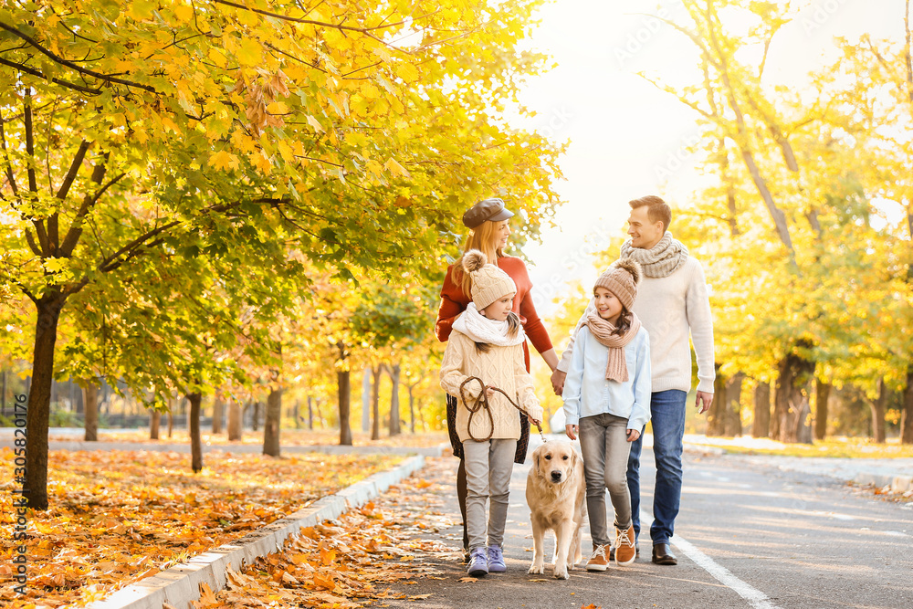 Happy family with dog walking in autumn park Happy family with dog walking in autumn park