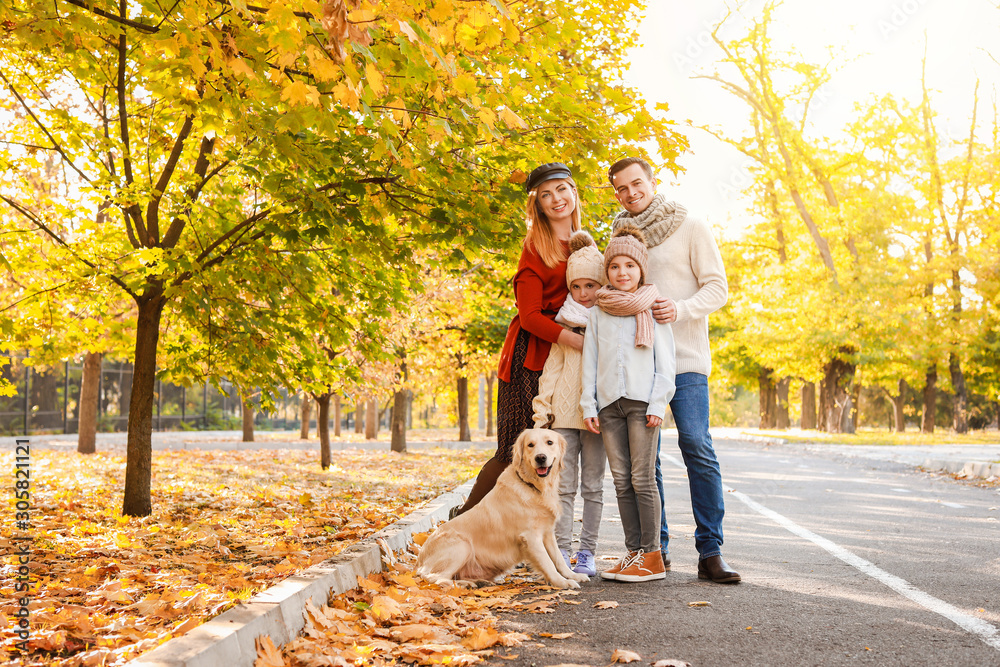 Fototapeta premium Happy family with dog in autumn park