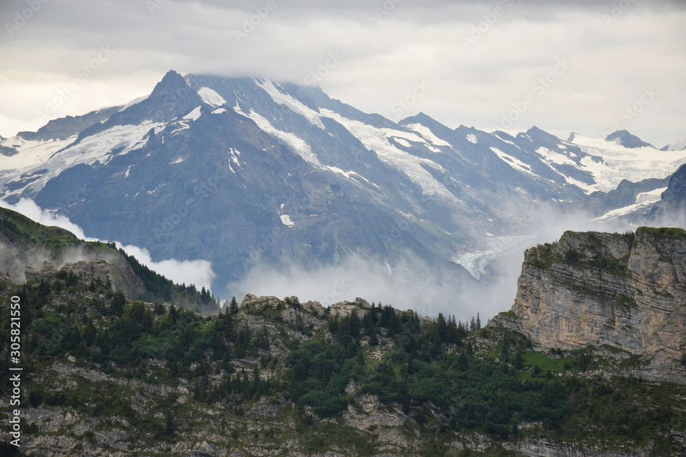 Mist coming over a piece of mountain in the Jungfrau Region, Switzerland