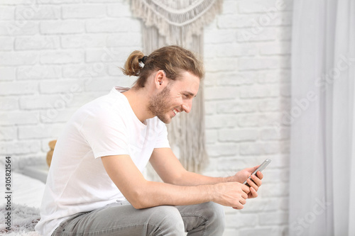 Young man with hearing aid ...