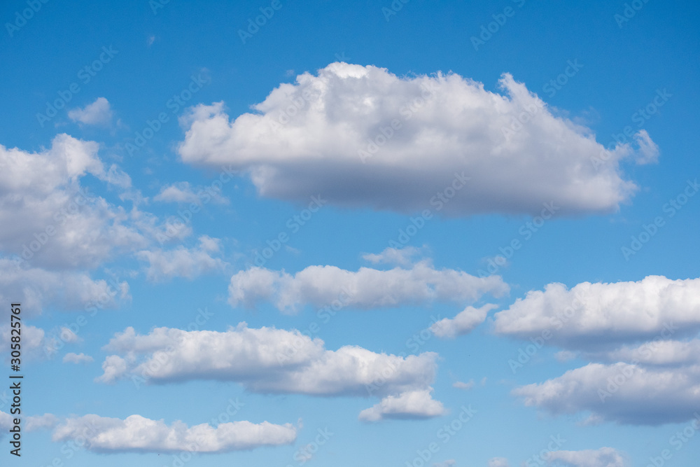 Fluffy white clouds in a beautiful blue sky Fluffy white clouds in a beautiful blue sky