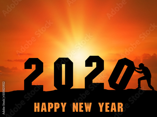 Happy New Year 2020 Silhouette sunset. The man carrying numbers 2020 lined up on the mound. Sunset time